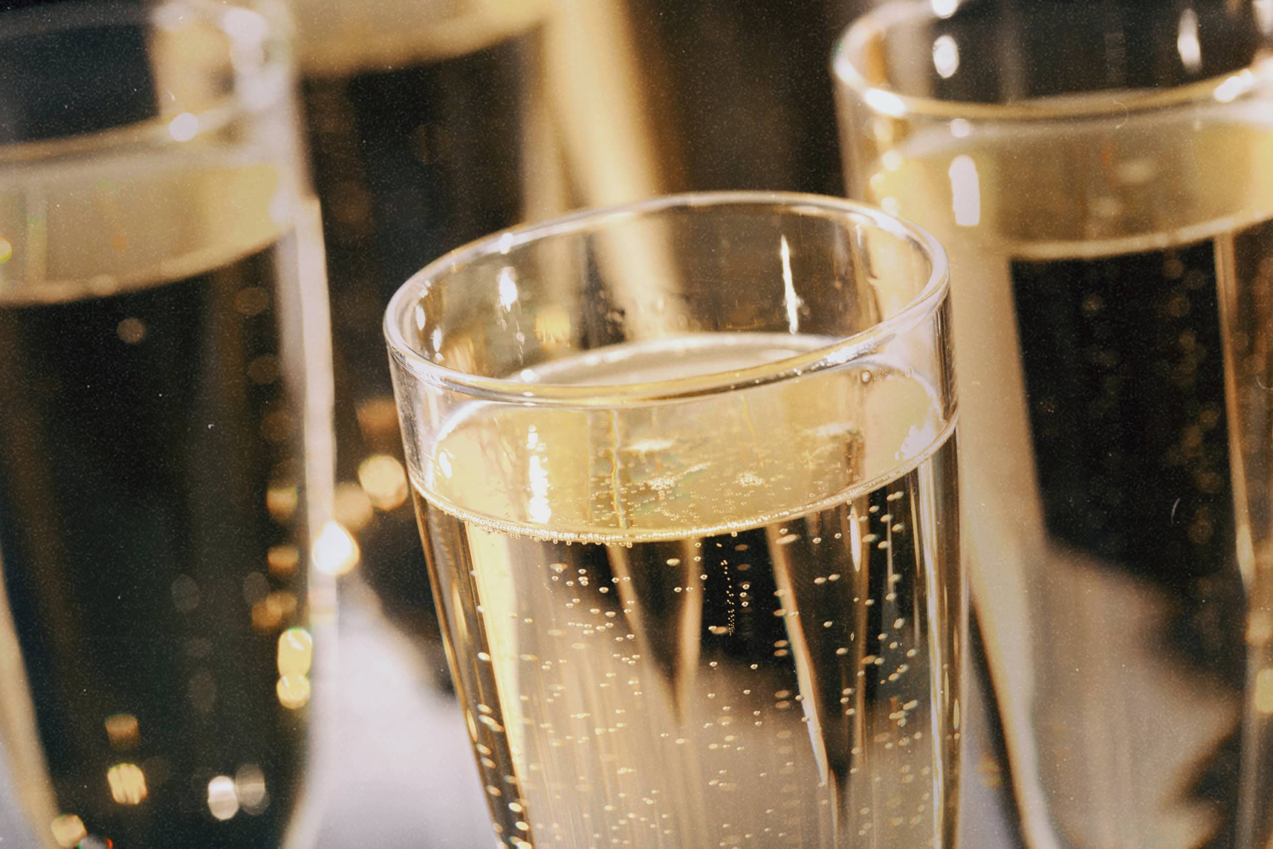 Close-up of champagne bubbles rising, showcasing a celebratory moment provided by Golden Service Mobile Bar for events in Halifax.