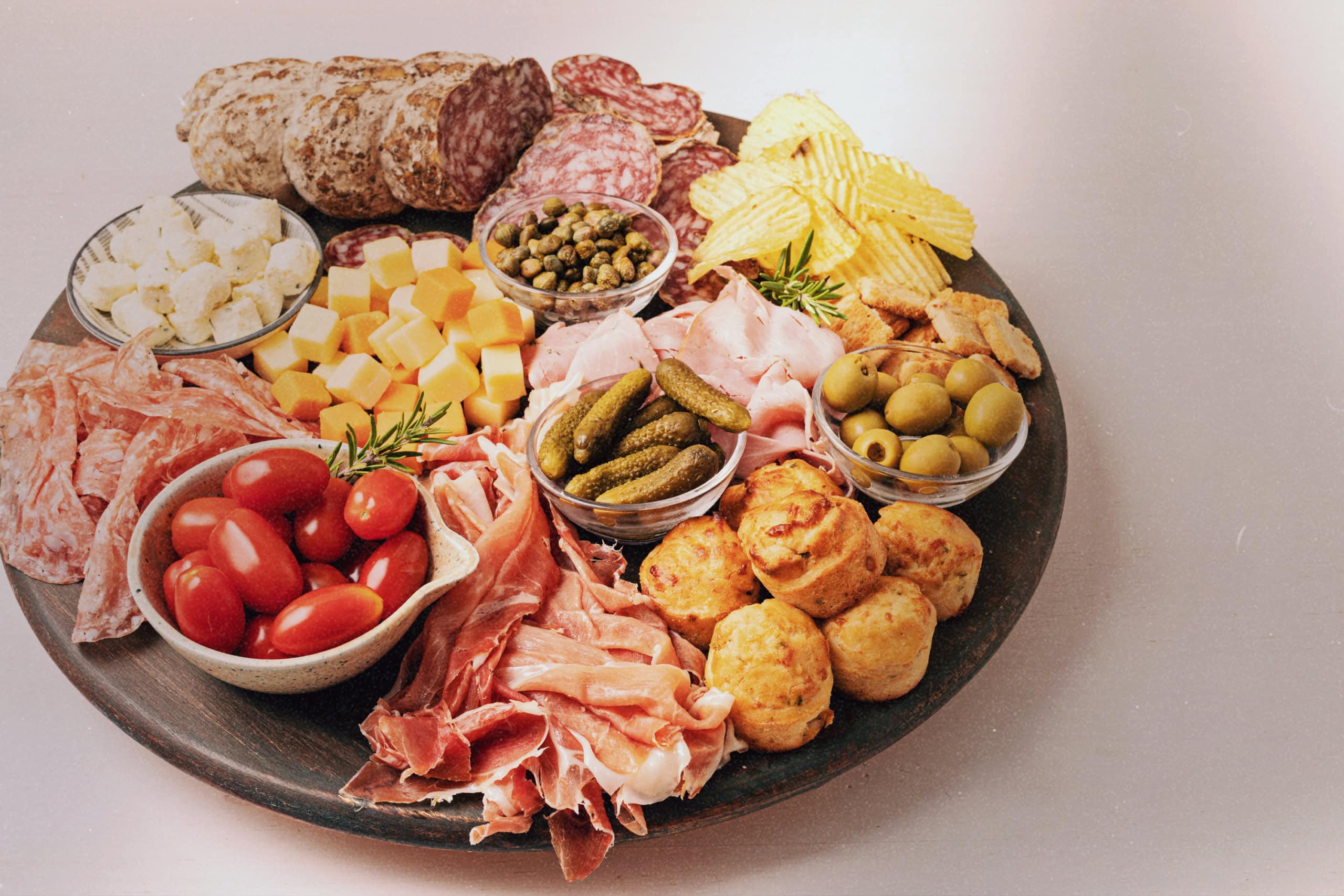 Charcuterie board on a table, offering a selection of meats, cheeses, and fruits, provided by Golden Service Mobile Bar for weddings and events in Halifax.