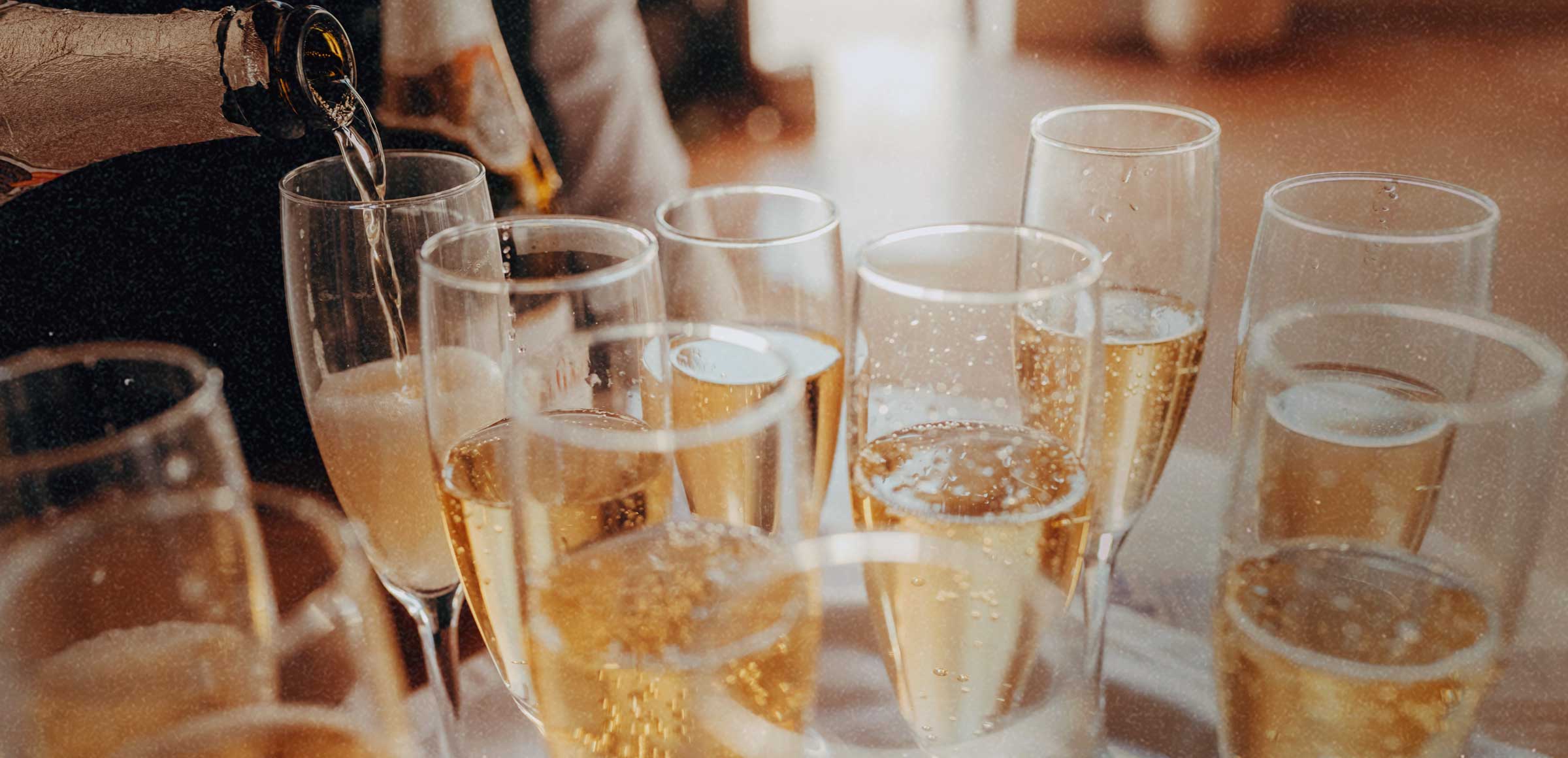 Golden Service Mobile Bar pouring champagne at a Halifax wedding event